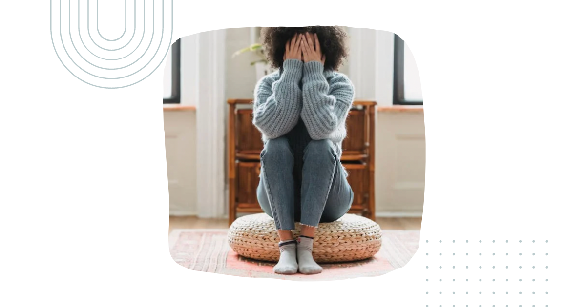 Image of a woman with depression covering her face