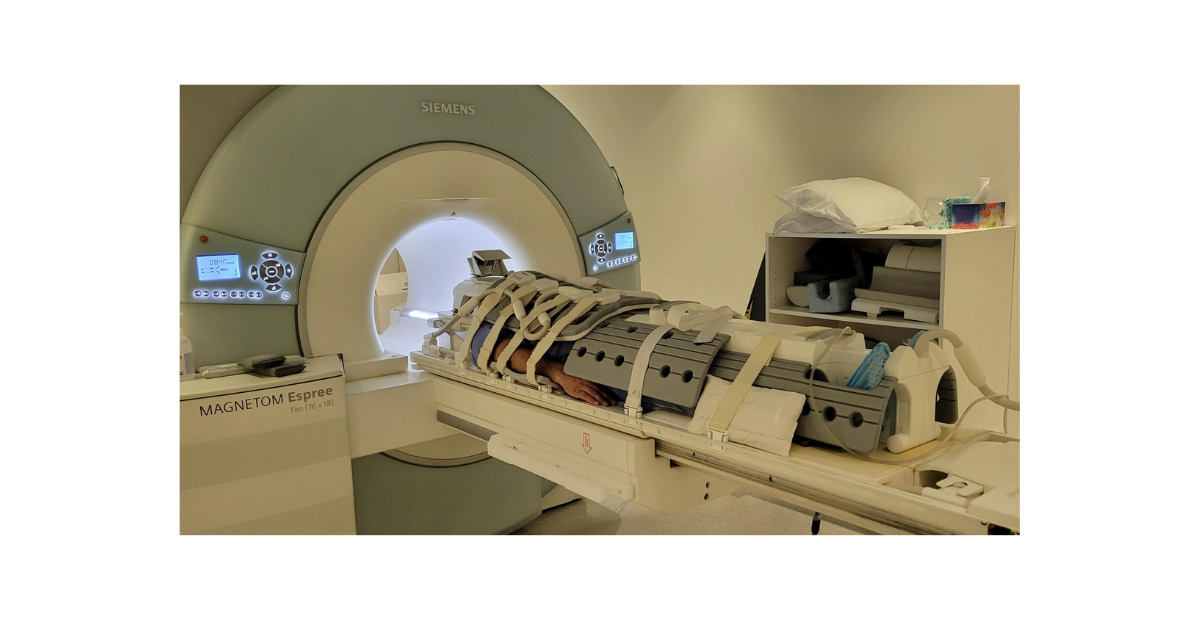 A man is covered in MRI coils from head to toe while laying on the scan table of the MRI machine just before he begins his whole body MRI scan at Prenuvo